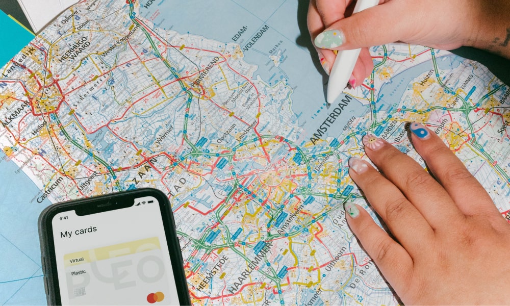Photo of a phone and hand marking a map